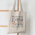 Detailed view of cream canvas tote bag with Matisse art print hanging on a ladder - Matisse Art Style (1) / 39cm*35cm