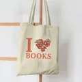Close-up detail of 'I Love Books' print on a cream canvas tote bag hanging on a ladder - Book Heart Print (5) / 39cm*35cm