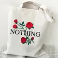 Minimalist white canvas tote bag featuring red rose graphics and NOTHING text print - Rose and Text (STD2097-E)
