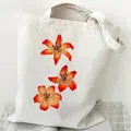 Durable white canvas tote bag featuring a vibrant orange lily floral print design - Lily Floral (STD2097-K)