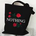 Minimalist black canvas tote bag featuring red rose graphics and NOTHING text print - Rose and Text (STD2097-M Black)