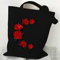 Black canvas tote bag featuring a vibrant red rose crescent moon graphic floral print - Red Rose Moon (STD2097-N Black)