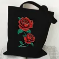 Durable black canvas tote bag featuring an artistic red rose graphic print design - Double Rose (STD2097-O Black)