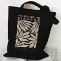 Minimalist black canvas tote bag with floral print and Bible verse 'Seek First His Kingdom' - Bible Verse (STD2097-S Black)