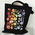 Durable black canvas tote bag featuring a vibrant watercolor floral garden print - Rainbow Floral (STD2097-T Black)