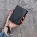 Elegant compact women's black litchi pattern wallet featuring a stylish tassel charm - Black