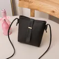 Elegant minimalist black plain texture bucket bag featuring a sleek gold buckle detail - Black