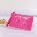 Vibrant pink crocodile embossed pattern women's clutch bag with a wristlet strap - Rose Red