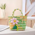 Hand-woven colorful basket handbag featuring a decorative pink flower charm charm. - Decorated / Small (Bottom 16x15x9cm, Top 22cm) / Orange and Green