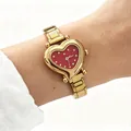 Detail view of a golden stainless steel heart-shaped quartz watch on a wrist. - Gold Modular Heart Red (5522) / Gold