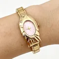 Detailed view of a unique gold-toned fish-shaped watch with a pink dial on wrist - 5464-Gold Pink