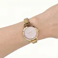 Macro view of a gold stainless steel watch with a purple glitter dial on a wrist - Gold Pink Dial Modular Watch(4618) / Gold