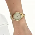 Close-up view of a stylish gold modular stainless steel watch worn on a woman's wrist - Gold Yellow Dial Modular Watch(4619)