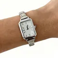 Elegant women's rectangular silver steel strap quartz watch displayed on a wrist - Silver Square Dial White
