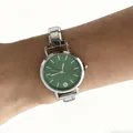 Close-up of a silver modular stainless steel watch with a green dial on a wrist. - Green Dial Modular Watch(4621)