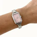 Close-up of a elegant women's quartz watch with pink dial and silver steel band on wrist - Silver Square Dial Pink