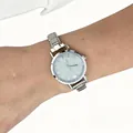 Close-up of a silver stainless steel watch with a shimmering glitter dial on a wrist - Cream Dial Modular Watch(4622)