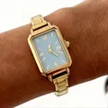 Close-up of elegant gold rectangular lady's watch with blue dial on wrist - Light Blue Style (4642) / Gold Square Dial Blue