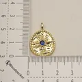 Macro view of a gold stainless steel star charm with a central blue stone for jewelry - Sun Starburst Style (1)
