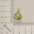 Detailed view of a gold monkey head pendant with crystal accents on a ruler. - Monkey Head Style (2)