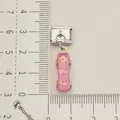 Macro view of a pink skateboard Italian modular charm with golden musical note patterns - Pink Note Skateboard Charm (Single 3)