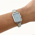 Detail view of an elegant silver steel band quartz watch with a light blue dial. - Silver Square Dial Light Blue