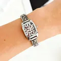 Detailed view of a silver ladies' quartz watch featuring a leopard print dial and modular strap - Leopard Square Dial Style / Silver