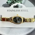 Close-up of golden women's quartz watch with oval dial and stainless steel band - Oval Black Dial Modular Style (5157) / Gold