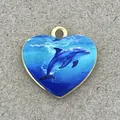 Detailed view of a gold-rimmed heart pendant featuring a blue dolphin ocean scene - Dolphin Heart Style