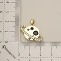 Gold planet pendant with blue stones and white crystals shown next to a ruler for scale - Planet Saturn Style (6)