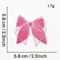 Macro detail of pink bow embroidery patch showing exact dimensions 5.6cm by 5.8cm - Pink Bow Style 2 (Striped)