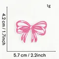 Detailed view of a pink embroidered bow patch showing precise measurement markers - Pink Bow Style 6 (Bi-color)