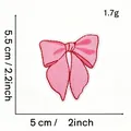 Detailed view of pink bow embroidered patch showing 5x5.5cm dimensions and 1.7g weight - Pink Bow Style 11 (With Heart)