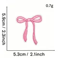 Detailed dimensions of pink bow embroidery patch showing 5.3cm x 5.9cm and 0.7g weight - Pink Bow Style #23 (3D Edge)