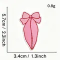 Detailed product view of a pink bow embroidered patch with precise metric size measurements - Pink Bow Style #25 (Slim Ribbon Red Border)