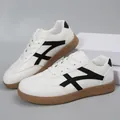 Detail view of white German trainers with black stripes and gum sole, casual style - 36 / White