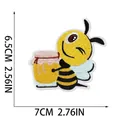 Detailed close-up view of a cartoon bee embroidery patch with size dimensions 7x6.5cm - Bee Holding Pot (W18MF-12-13) / 7x6.5cm