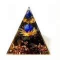 Detailed macro view of an Orgonite pyramid with gold foil, lotus, and blue sphere - C1 Lapis Lazuli + Lotus + Obsidian / 5cm