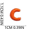 Detailed view of mini orange embroidered letter C patch with 1.1cm by 1cm dimensions - Letter C