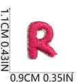 Detailed macro shot of a small pink embroidered letter R patch with size measurements - Letter R / 1 Piece