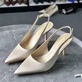 Side view of elegant beige satin pointed-toe slingback high heels on a stone table - 38 / Wide Version / 4.50cm / Nude