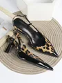 Detailed view of pointed-toe leopard print slingback heels with glossy black accents. - 35 / Black Leopard