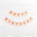Detailed view of pink gold foil Happy Birthday swallowtail banner in party setting - Swallowtail Banner / Light Pink