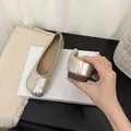 Close-up of flexible champagne gold split-toe Tabi ballet flats in soft leather. - Champagne