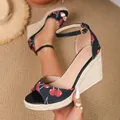 Close-up of black cherry print wedge sandals with straw platform and ankle strap. - 35 / Black