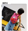 Toddler wearing a bright pink cartoon dinosaur schoolbag featuring colorful animal patterns - Rose Red
