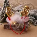 Close-up of a Christmas reindeer antler headband with golden horns and white fur trim on a log - Classic Gold Large Headband