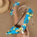 Close-up of stylish lemon print blue pointed toe high heel pump with gold stiletto - 35 / Sky Blue