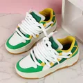 Detail of chunky green and white platform sneakers with thick decorative rope laces. - 35 / White Green