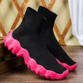 Detail view of women's black knit sock sneakers with a chunky pink wavy sole profile - 35 / Black with Rose Red Sole